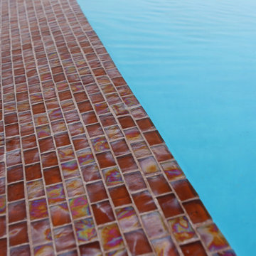 Glass tile projects- 1” X 2” iridescent red glass tile cover the 65 foot infinit