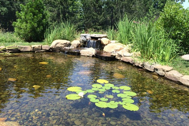 Design ideas for a mid-sized traditional partial sun side yard water fountain landscape in New York for summer.