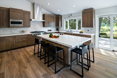 Inspiration for an expansive contemporary u-shaped open plan kitchen in Orange County with shaker cabinets, distressed cabinets, quartz benchtops, white splashback, stainless steel appliances, porcelain floors, with island and multi-coloured floor.