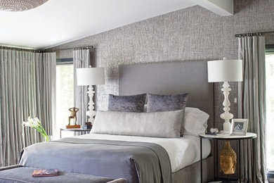 Example of a large trendy master dark wood floor and brown floor bedroom design in New York with gray walls