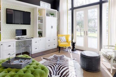 Inspiration for a mid-sized transitional built-in desk dark wood floor and brown floor study room remodel in Tampa with black walls