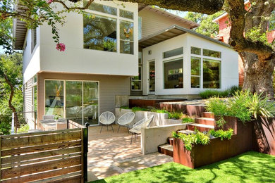 Trendy white split-level exterior home photo in Austin with a shed roof