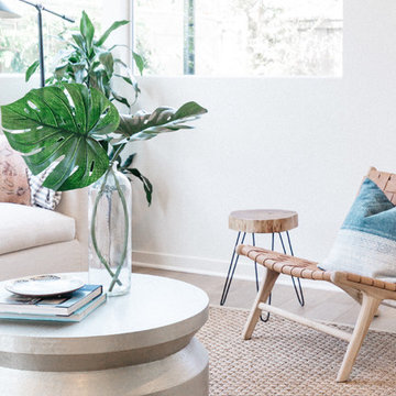 White Slipcovered Sofa with Woven Leather Chair and Palm Leaves