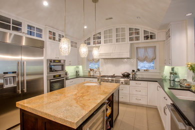 Inspiration for a large timeless u-shaped porcelain tile and beige floor kitchen remodel in Chicago with a double-bowl sink, shaker cabinets, white cabinets, soapstone countertops, white backsplash, subway tile backsplash, stainless steel appliances, an island and black countertops