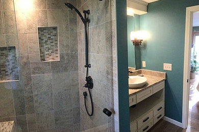 Alcove shower - small contemporary master beige tile and mosaic tile alcove shower idea in Other with a vessel sink, shaker cabinets, white cabinets, granite countertops, a one-piece toilet and green walls