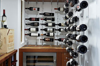 Example of a small tuscan ceramic tile wine cellar design in Tampa