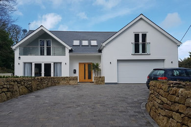 Design ideas for a medium sized and white beach style two floor render house exterior in Cornwall with a pitched roof.