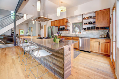 Inspiration for a small contemporary galley light wood floor eat-in kitchen remodel in Denver with recessed-panel cabinets, medium tone wood cabinets, quartzite countertops, multicolored backsplash, mosaic tile backsplash, stainless steel appliances, a single-bowl sink and an island