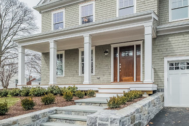 Inspiration for a mid-sized transitional gray two-story wood gable roof remodel in New York