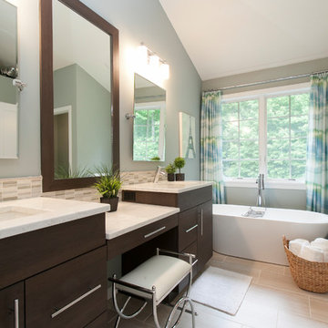 Dark Stained Cabinetry and Shapely Freestanding Tub