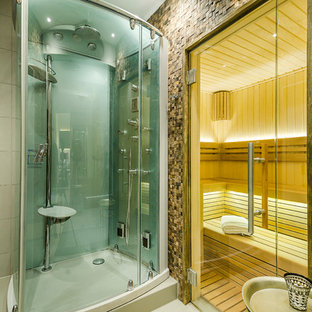 Inspiration for a small contemporary fully buried basement in London with grey walls, light hardwood flooring and grey floors.