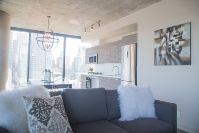 Large transitional formal and open concept medium tone wood floor and gray floor living room photo in Toronto with white walls and no tv