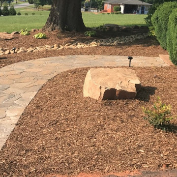 Interlocking paver patio, dry creek bed and boulder wall