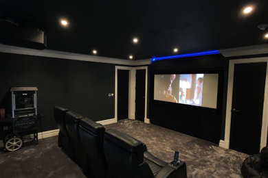 This is an example of a contemporary home theatre in Berkshire.
