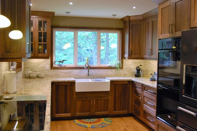 Mid-sized transitional u-shaped medium tone wood floor and brown floor kitchen pantry photo in Toronto with a farmhouse sink, shaker cabinets, medium tone wood cabinets, quartzite countertops, beige backsplash, mosaic tile backsplash, a peninsula and black appliances