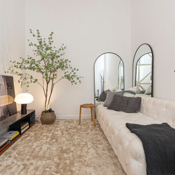Living Room Sofa, Low Media Console and Arched Mirrors