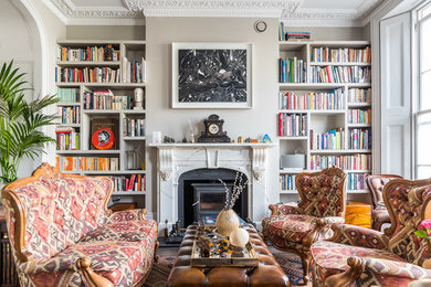 This is an example of a mid-sized eclectic enclosed living room in London with grey walls.