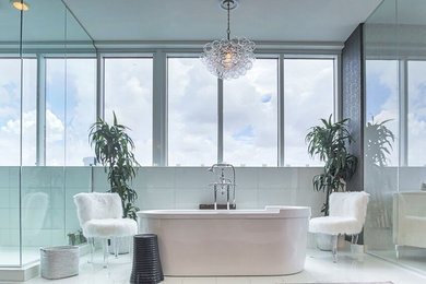 Inspiration for a contemporary white tile and porcelain tile white floor bathroom remodel in Miami with a hinged shower door