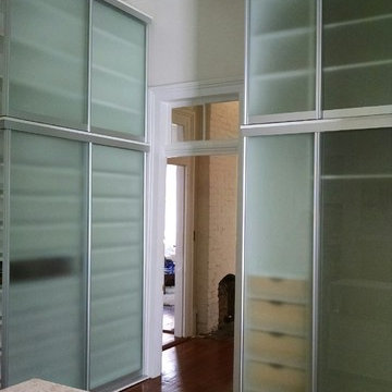 Master Closet with Shoe Storage, Island, and Window Seat