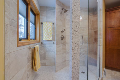 Large contemporary master bathroom in Milwaukee with shaker cabinets, medium wood cabinets, an open shower, a two-piece toilet, gray tile, porcelain tile, beige walls, porcelain floors, an integrated sink, solid surface benchtops, grey floor and an open shower.