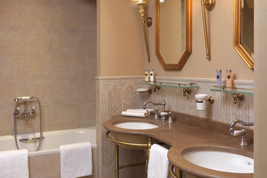 На фото: ванная комната в классическом стиле с бежевой плиткой, керамогранитной плиткой и врезной раковиной