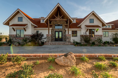 Inspiration for a large rustic white two-story mixed siding house exterior remodel in Sacramento with a gambrel roof and a metal roof