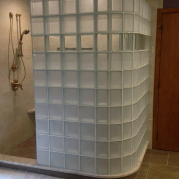 Curved glass block shower in spa like bathroom