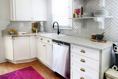 Small traditional galley eat-in kitchen in New York with a drop-in sink, recessed-panel cabinets, white cabinets, quartz benchtops, white splashback, subway tile splashback, stainless steel appliances, light hardwood floors and no island.