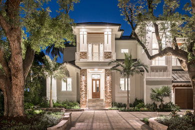 Large transitional white two-story house exterior idea in Other with a metal roof