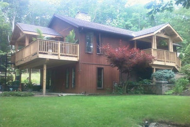 Example of a mid-sized cottage brown two-story wood exterior home design in San Diego with a shingle roof