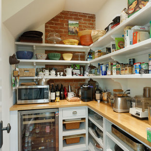 Photo of a large traditional kitchen pantry in Cincinnati with an undermount sink, recessed-panel cabinets, blue cabinets, quartzite benchtops, beige splashback, ceramic splashback, panelled appliances, medium hardwood floors, with island and brown floor.