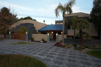 Inspiration for a large beige two-story mixed siding exterior home remodel in Phoenix