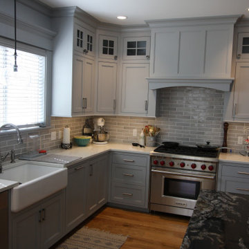 Custom Gray kitchen cabinetry with natural Black Walnut Island
