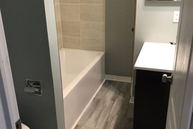 Example of a small transitional kids' beige tile and ceramic tile laminate floor, multicolored floor and single-sink bathroom design in Ottawa with furniture-like cabinets, brown cabinets, white walls, an undermount sink, solid surface countertops, white countertops, a niche and a built-in vanity