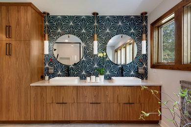 Photo of a large midcentury master bathroom in Minneapolis with flat-panel cabinets, dark wood cabinets, a japanese tub, a corner shower, a two-piece toilet, blue tile, porcelain tile, white walls, porcelain floors, an undermount sink, quartzite benchtops, grey floor, a hinged shower door, white benchtops, an enclosed toilet, a double vanity and a built-in vanity.
