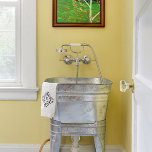 This is an example of a classic utility room in Raleigh with an utility sink and yellow walls.