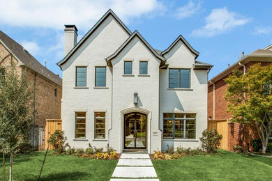 Example of a large transitional gray three-story brick house exterior design in Dallas with a shingle roof and a hip roof