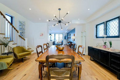 Mid-sized eclectic light wood floor dining room photo in Toronto with white walls