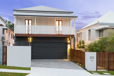 Photo of a mid-sized contemporary two-storey black exterior in Brisbane with wood siding and a gable roof.