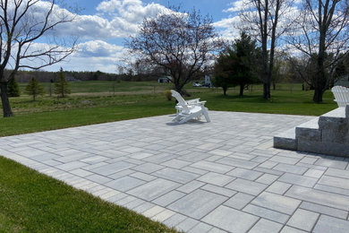 Mid-sized backyard concrete paver patio photo in Portland Maine