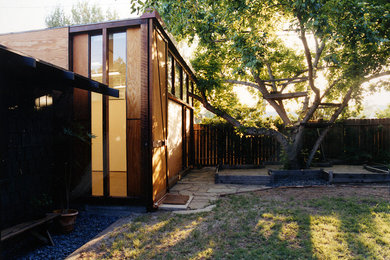 Inspiration for a mid-sized modern brown one-story wood flat roof remodel in Los Angeles