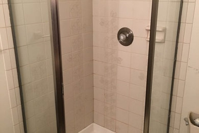 Corner shower - large contemporary 3/4 white tile and ceramic tile slate floor and gray floor corner shower idea in Seattle with shaker cabinets, brown cabinets, a one-piece toilet, blue walls, an integrated sink, quartz countertops and a hinged shower door