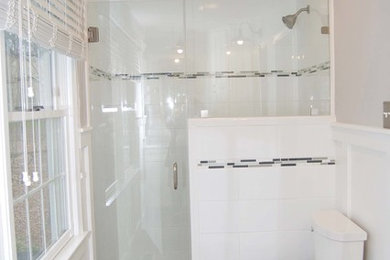 This is an example of a mid-sized transitional bathroom in Philadelphia with shaker cabinets, white cabinets, a two-piece toilet, white tile, porcelain tile, grey walls, ceramic floors, marble benchtops, an alcove shower and an undermount sink.