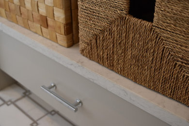 Alcove shower - mid-sized transitional master marble floor and white floor alcove shower idea in Providence with flat-panel cabinets, gray cabinets, a two-piece toilet, an undermount sink, quartz countertops, a hinged shower door and beige walls