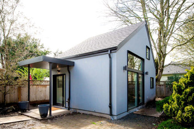 Inspiration for a small transitional blue one-story wood exterior home remodel in Portland with a shingle roof