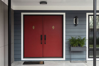 Inspiration for a 1960s entryway remodel in DC Metro with blue walls and a red front door