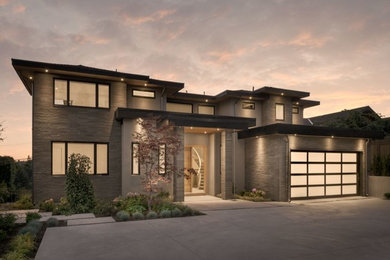 Large transitional gray stone exterior home idea in Vancouver