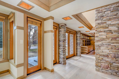 Inspiration for a light wood floor, brown floor and vaulted ceiling double front door remodel in Other with a medium wood front door