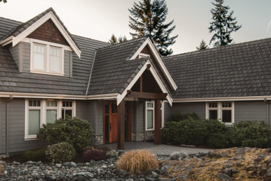Example of a mid-sized classic gray two-story concrete fiberboard and clapboard house exterior design in Vancouver with a tile roof and a gray roof