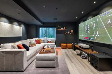 Inspiration for a contemporary home theater remodel in Denver with black walls and a projector screen